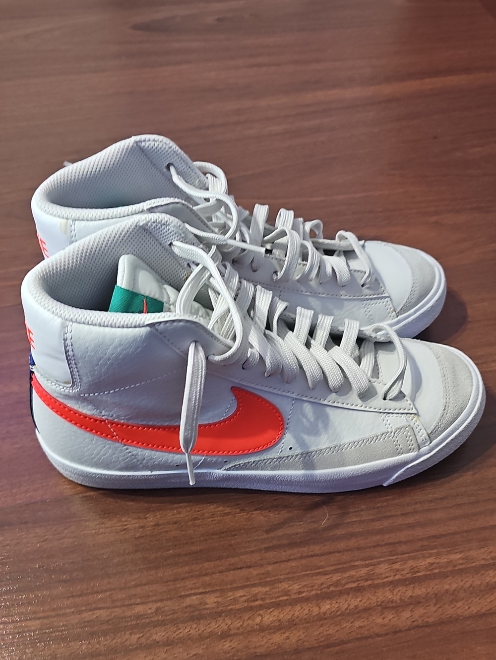 Nike Kids White High-Top Sneakers with Orange Swoosh